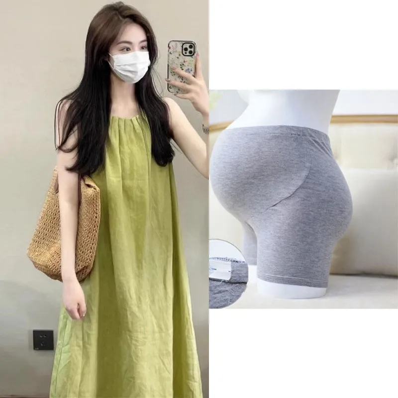 Plus size women's sleeveless asymmetric cotton vest skirt in green with black pants option on model