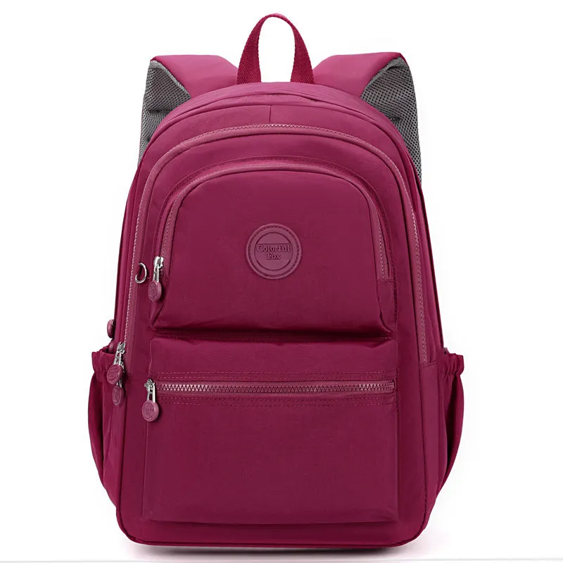 Women's nylon travel backpack in Azure Stone Green showing multiple compartments and organisational features