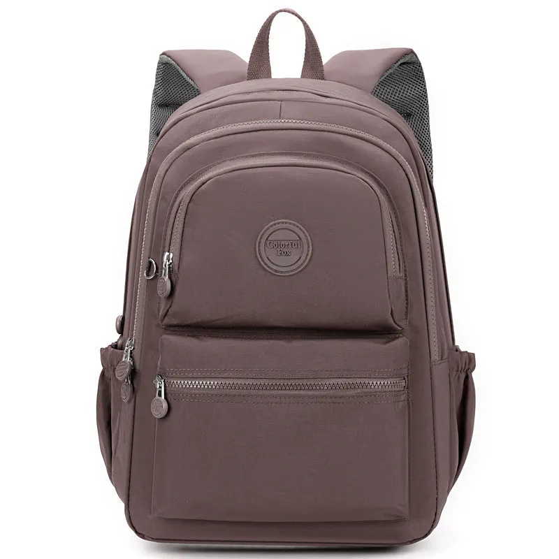 Women's nylon travel backpack in Azure Stone Green showing multiple compartments and organisational features