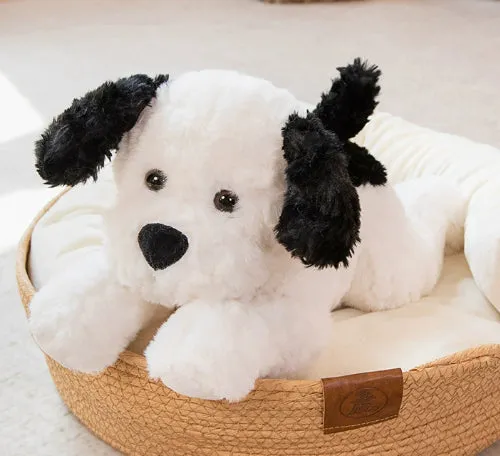 Plush toy lying dog doll in brown faux fur, 35cm height, lying on a soft surface