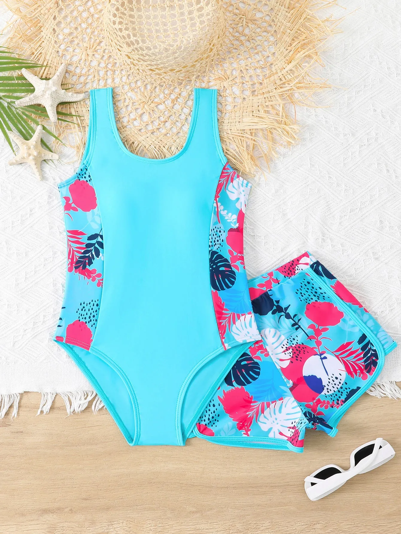Girls two-piece swimsuit set with one-piece top and boxer shorts in purple, blue, and rose red