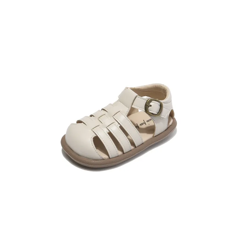 Girls' closed toe PU leather woven hollowed Roman sandals with Velcro strap, beige colour, on toddler feet