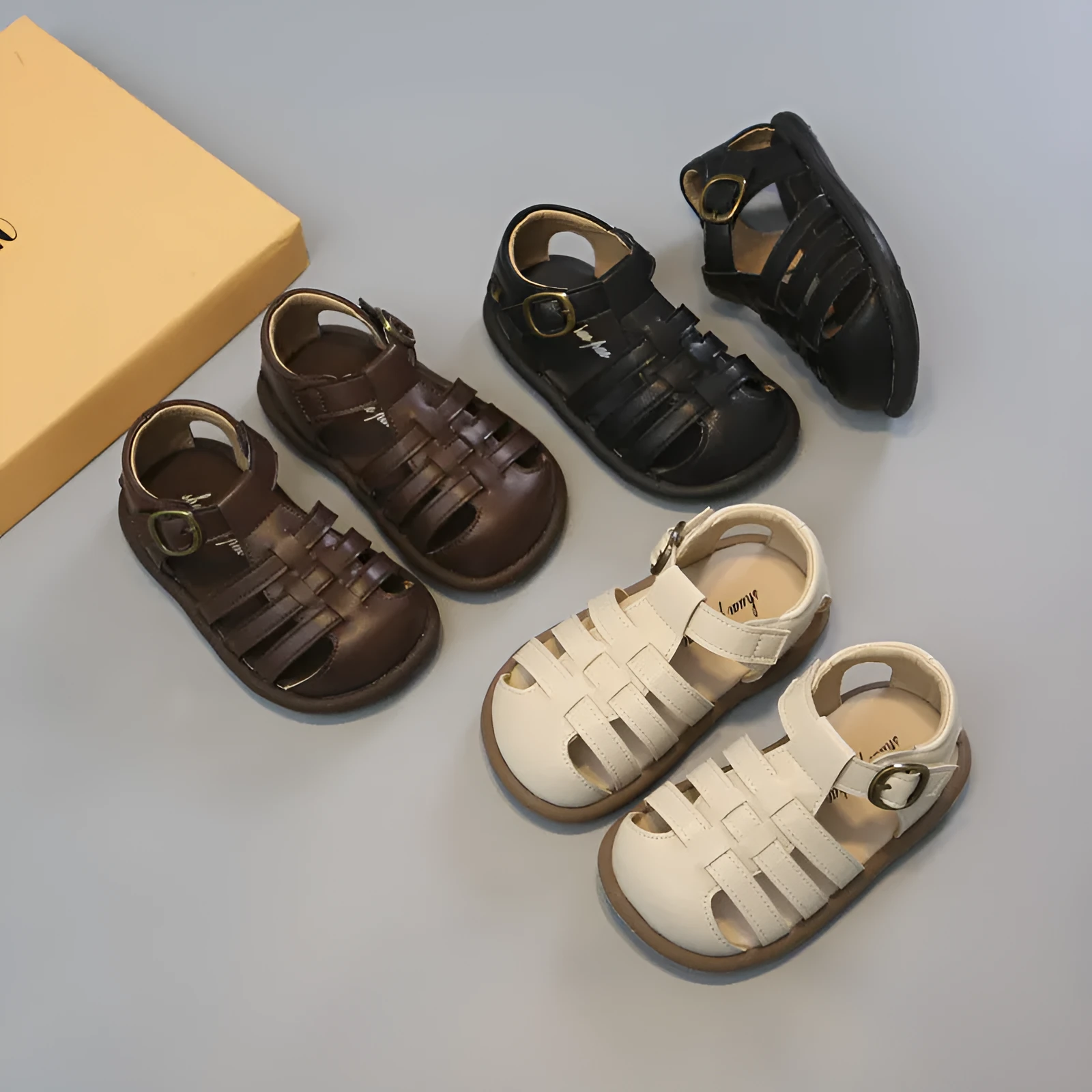 Girls' closed toe PU leather woven hollowed Roman sandals with Velcro strap, beige colour, on toddler feet