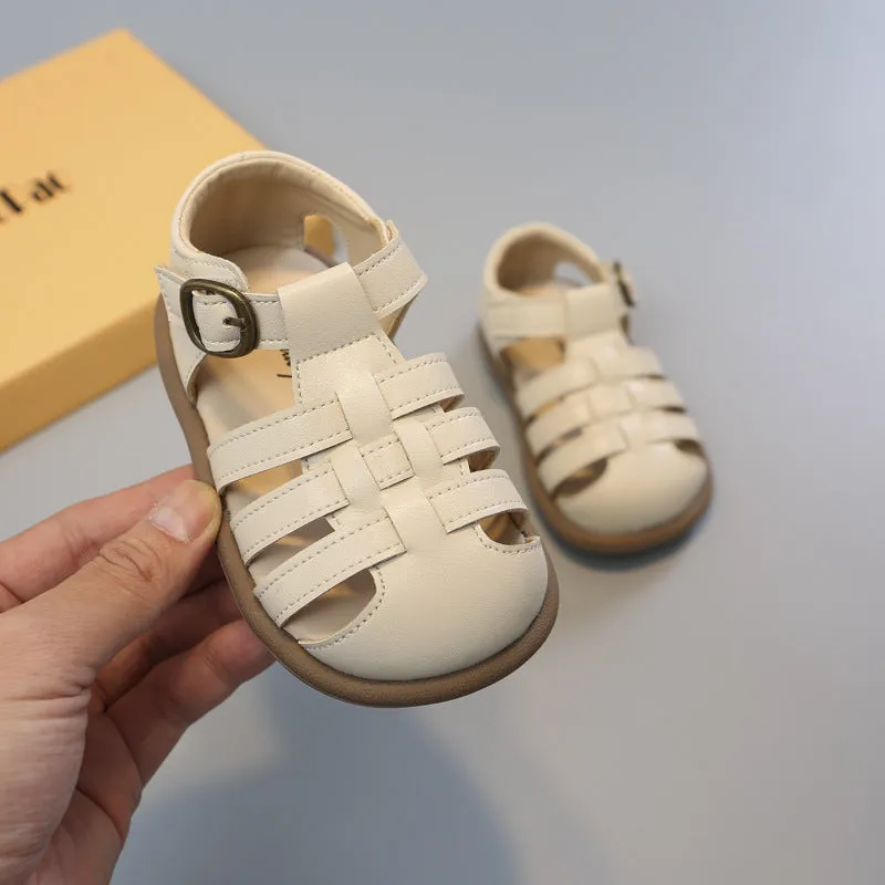 Girls' closed toe PU leather woven hollowed Roman sandals with Velcro strap, beige colour, on toddler feet