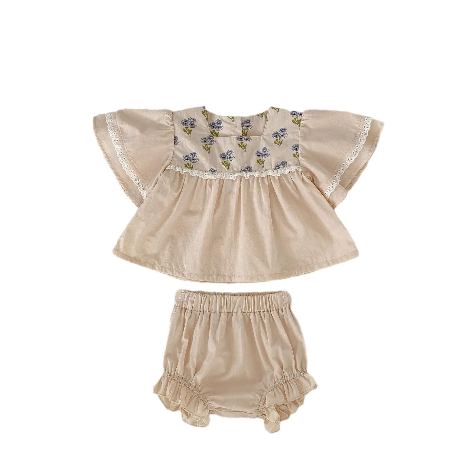 Apricot cotton two-piece suit with floral pattern, square collar top, and wooden horn buttons, next to matching bloomer pants.