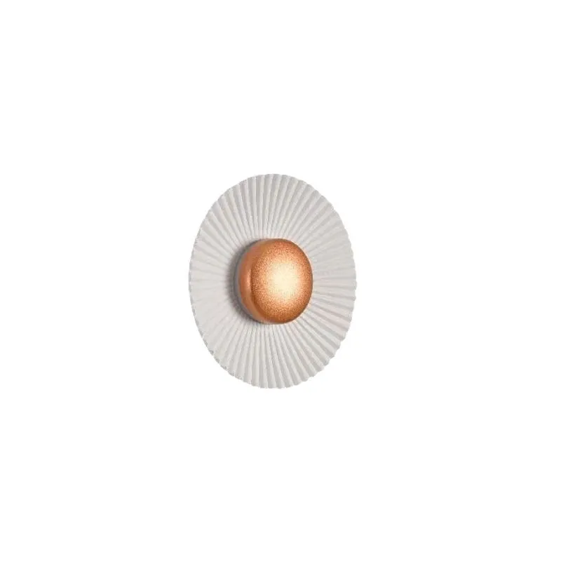 Round aluminium wall lamp in an outer white and inner gold colour combination, mounted on a wall.