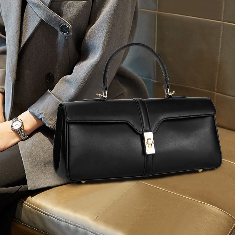Women's cylindrical leather messenger bag in black with internal organiser pockets