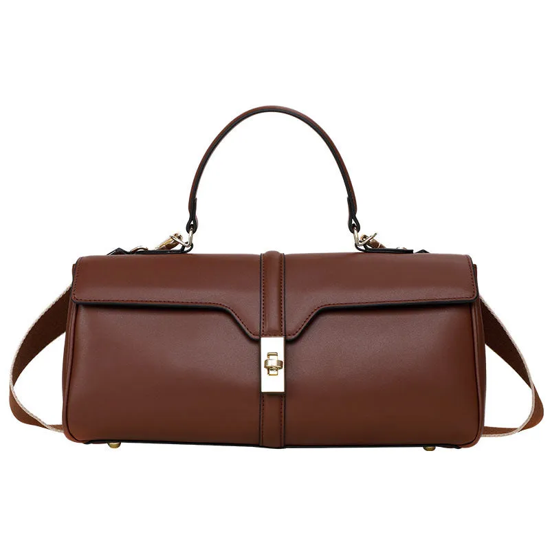 Women's cylindrical leather messenger bag in black with internal organiser pockets