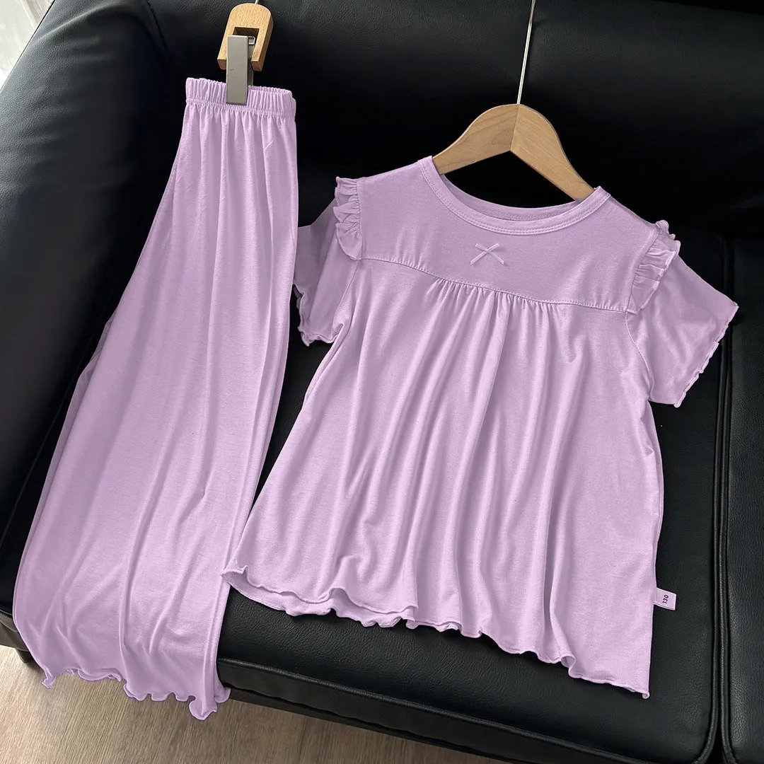 Girls' short sleeve modal pajama suit in solid colour, including top and pants, on a plain background