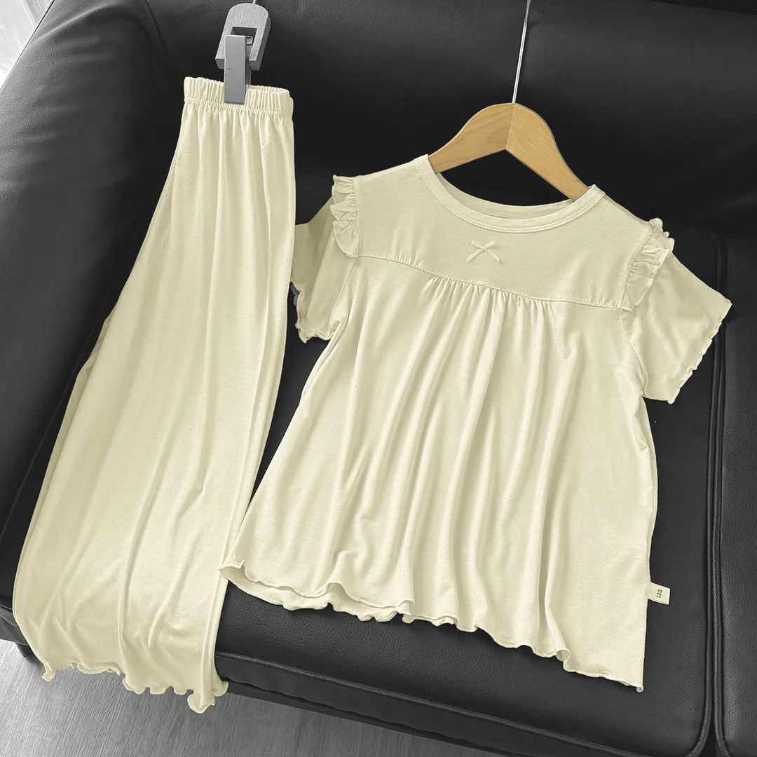 Girls' short sleeve modal pajama suit in solid colour, including top and pants, on a plain background