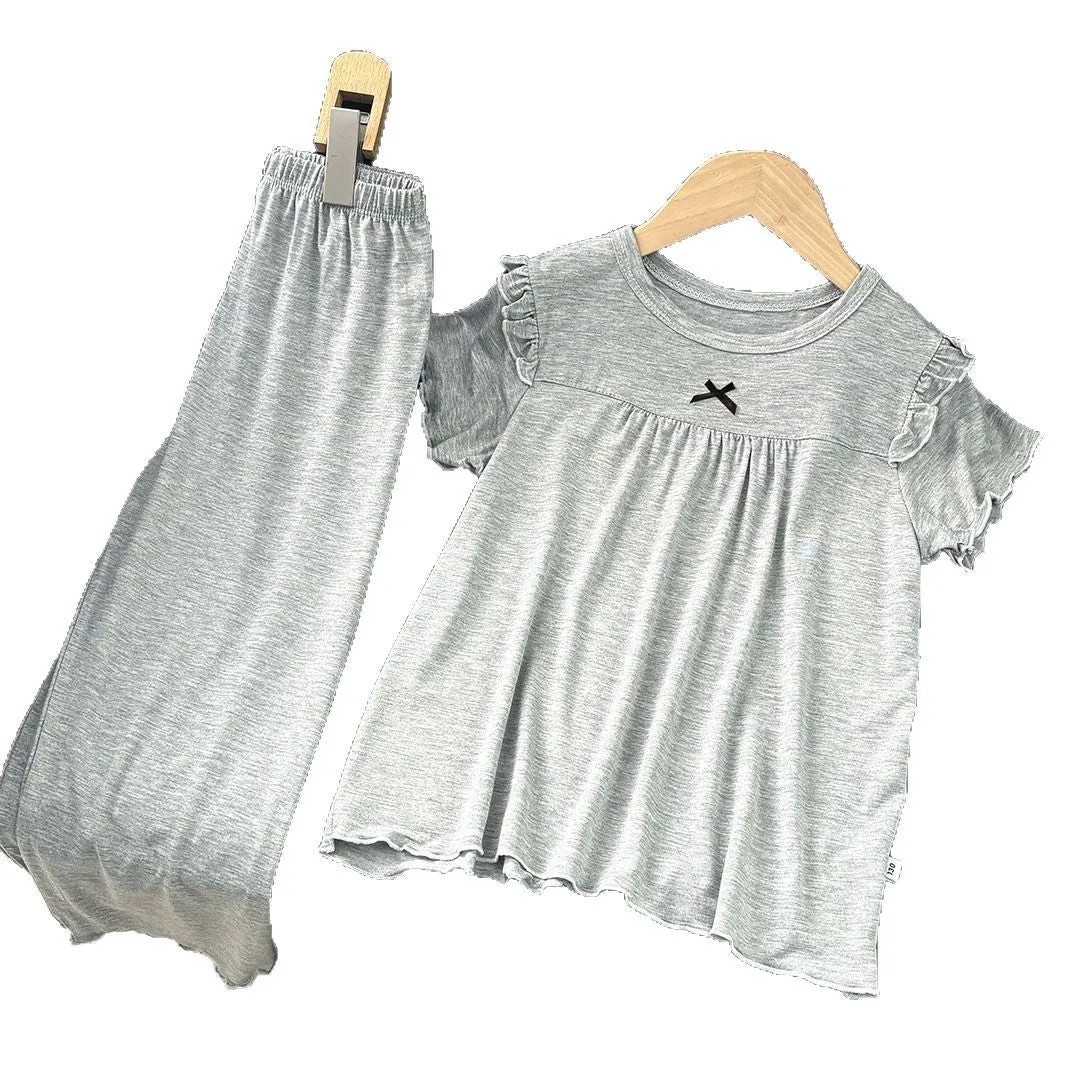 Girls' short sleeve modal pajama suit in solid colour, including top and pants, on a plain background