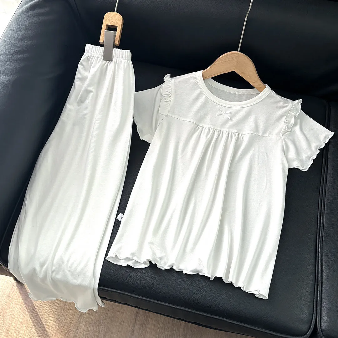 Girls' short sleeve modal pajama suit in solid colour, including top and pants, on a plain background