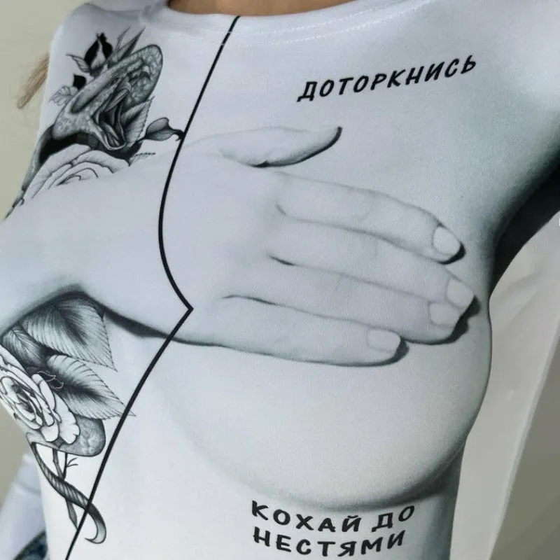 White slim fit polyester bodysuit with round neck, long sleeves, and fashion print on model