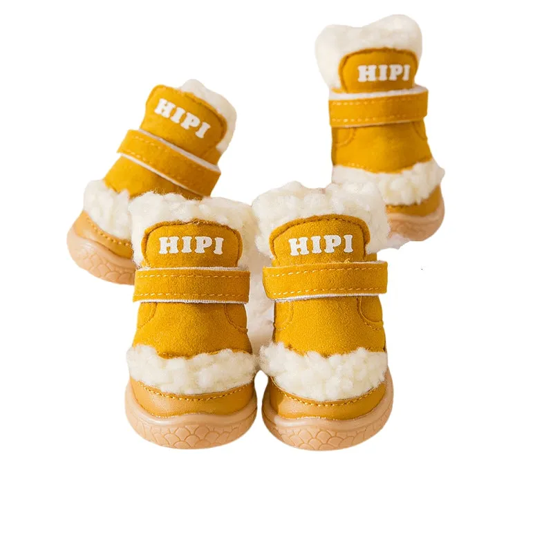 Brown winter dog shoes with adjustable Velcro straps and anti-slip rubber soles on a snowy surface