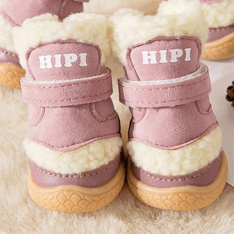 Brown winter dog shoes with adjustable Velcro straps and anti-slip rubber soles on a snowy surface