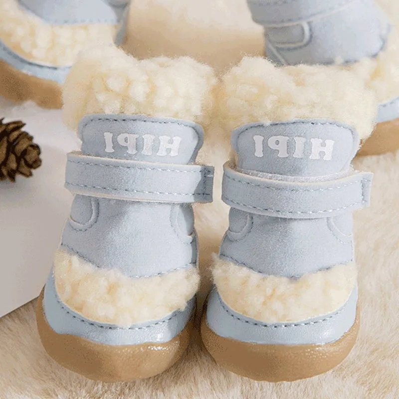 Brown winter dog shoes with adjustable Velcro straps and anti-slip rubber soles on a snowy surface
