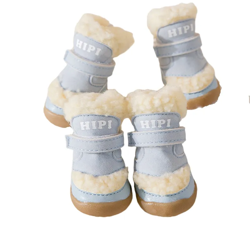 Brown winter dog shoes with adjustable Velcro straps and anti-slip rubber soles on a snowy surface
