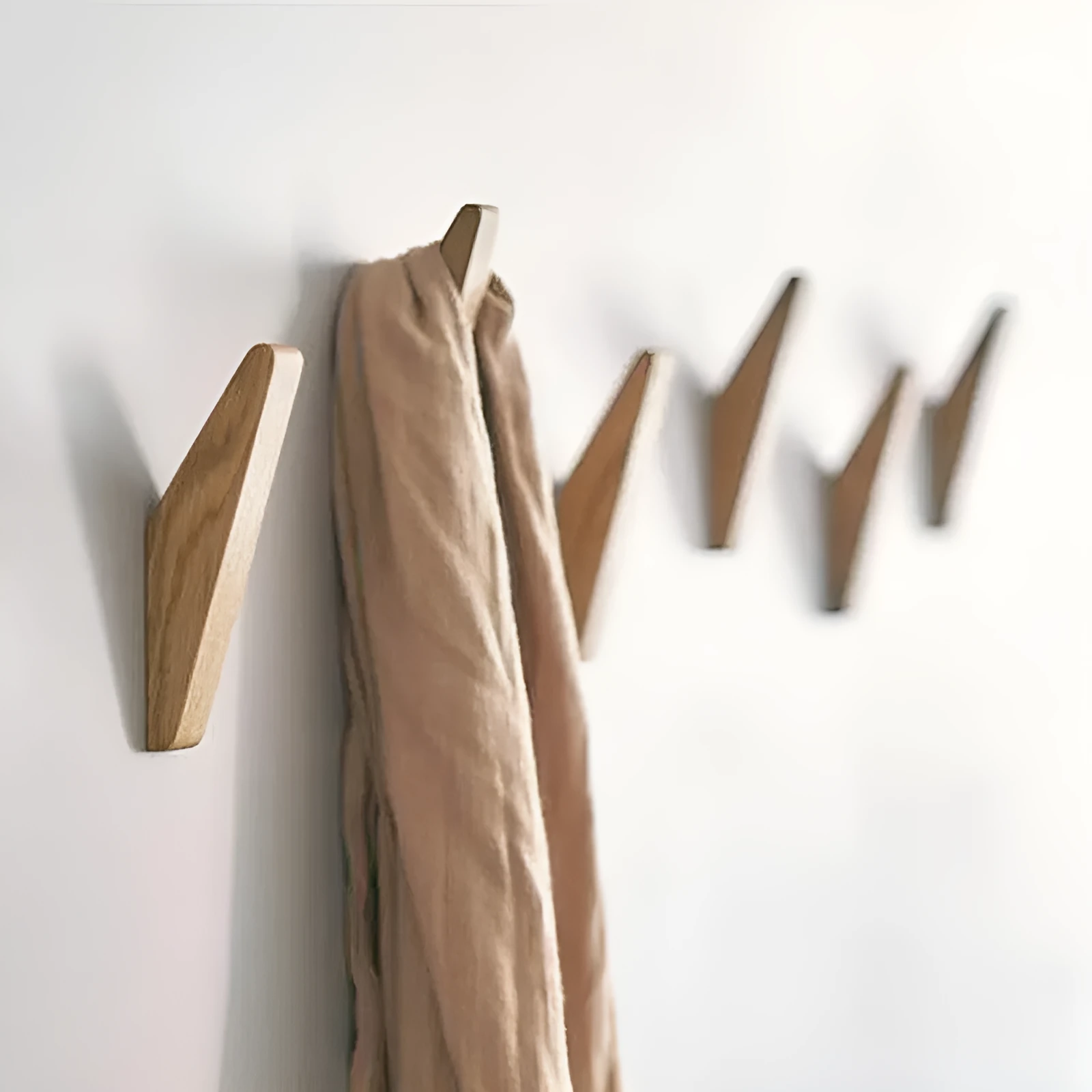 Triangle rubber wood wall hook with modern minimalist design for hanging coats and bags