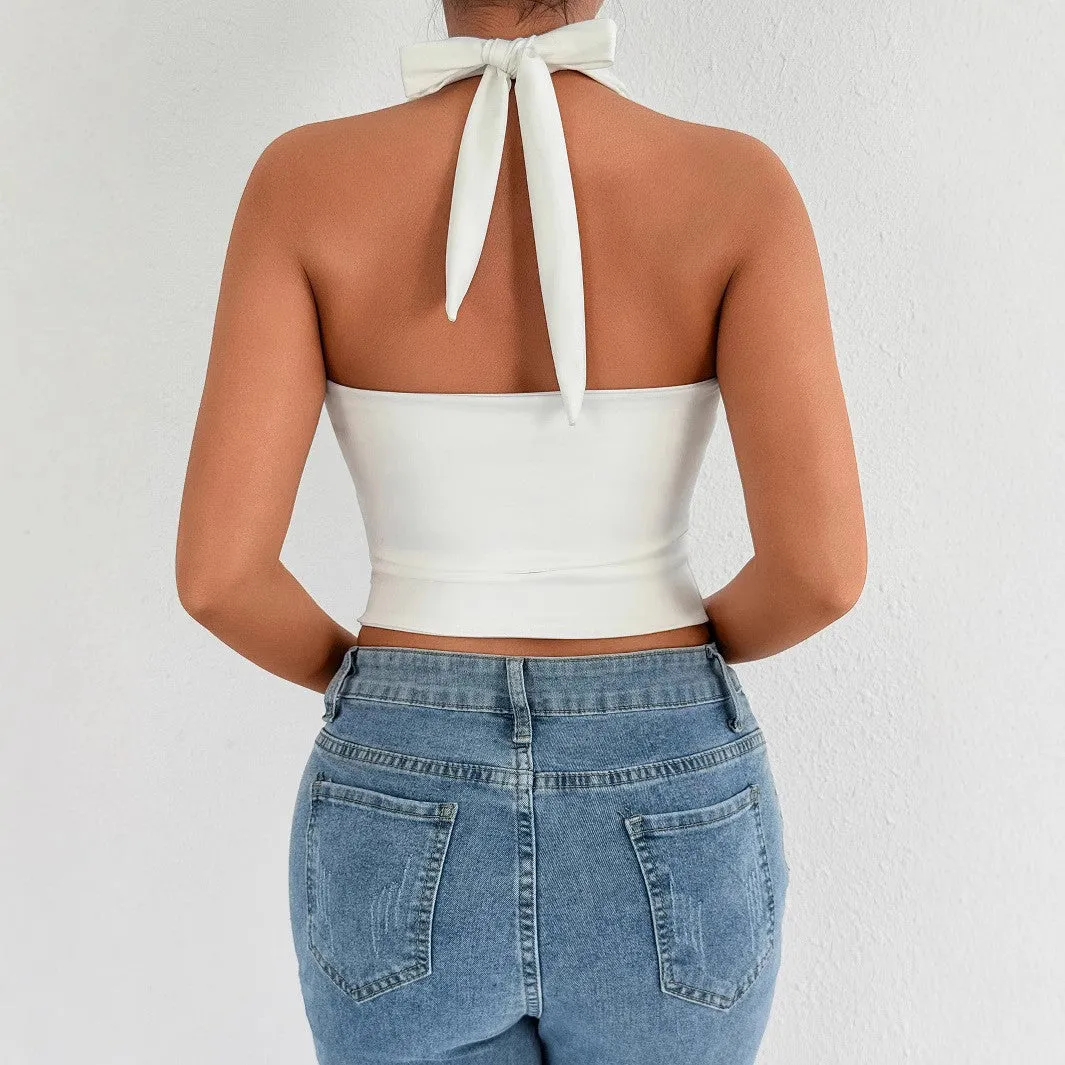 White sleeveless V-neck crop top with lace-up backless detail on woman against neutral background
