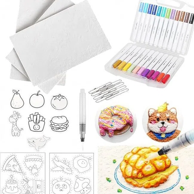 DIY brush set with foam grained paper, 12 marker pens, three fountain pens, beads, chain, and mini easel on a table