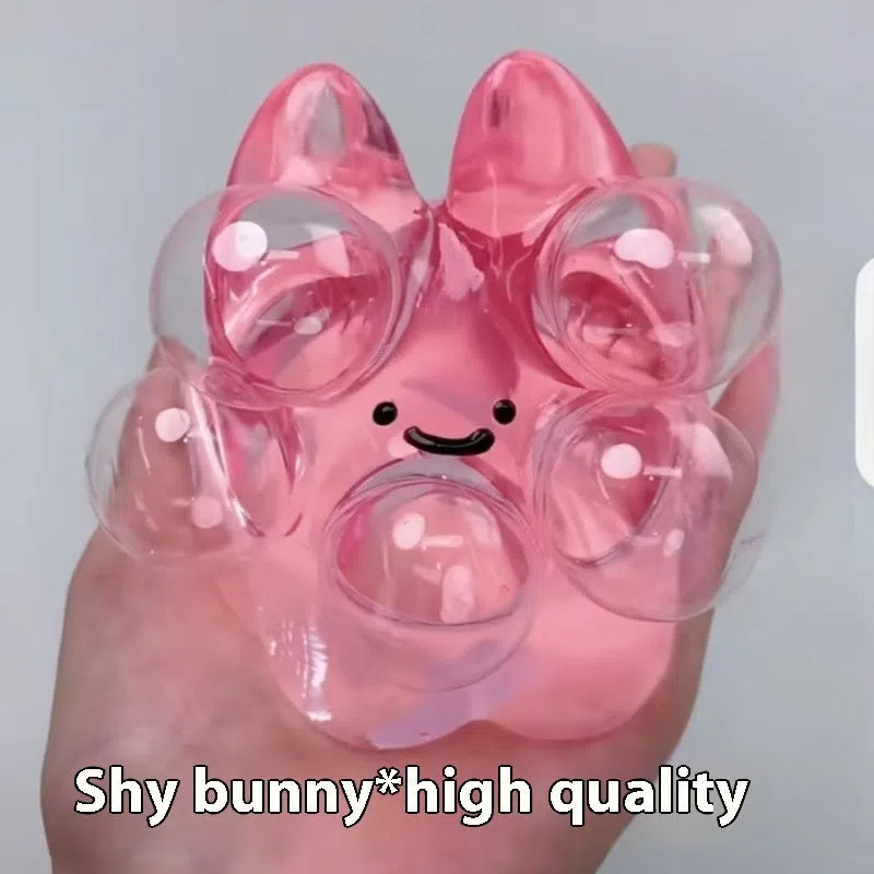 Decompression bubble slow rebound compressable musical toy in pink smiley ball design, made from TPR material for children's stress relief and sensory play