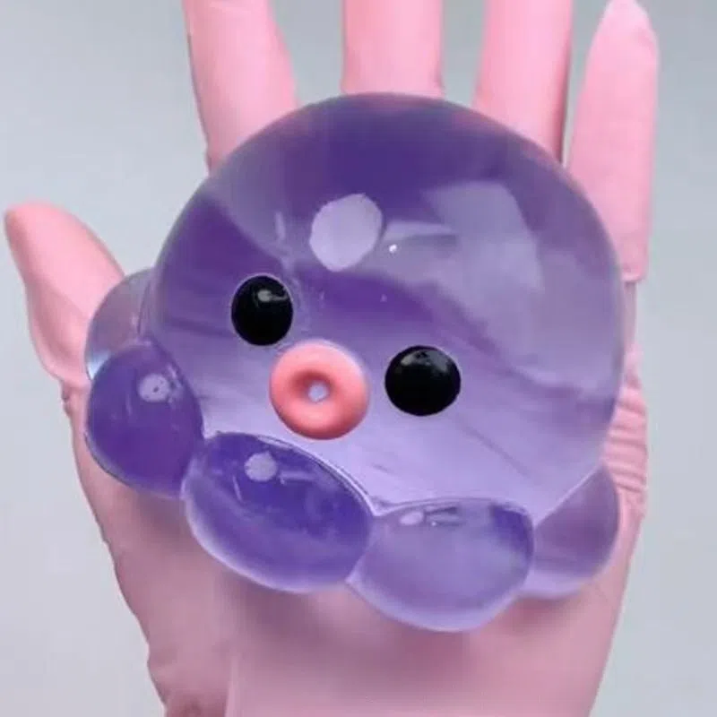 Decompression bubble slow rebound compressable musical toy in pink smiley ball design, made from TPR material for children's stress relief and sensory play