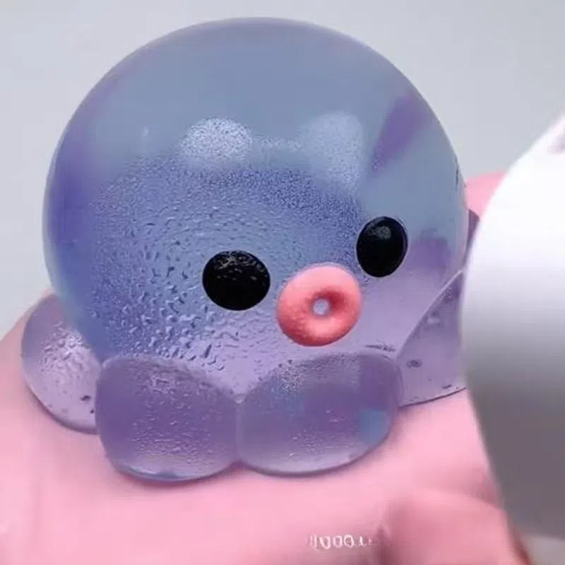 Decompression bubble slow rebound compressable musical toy in pink smiley ball design, made from TPR material for children's stress relief and sensory play