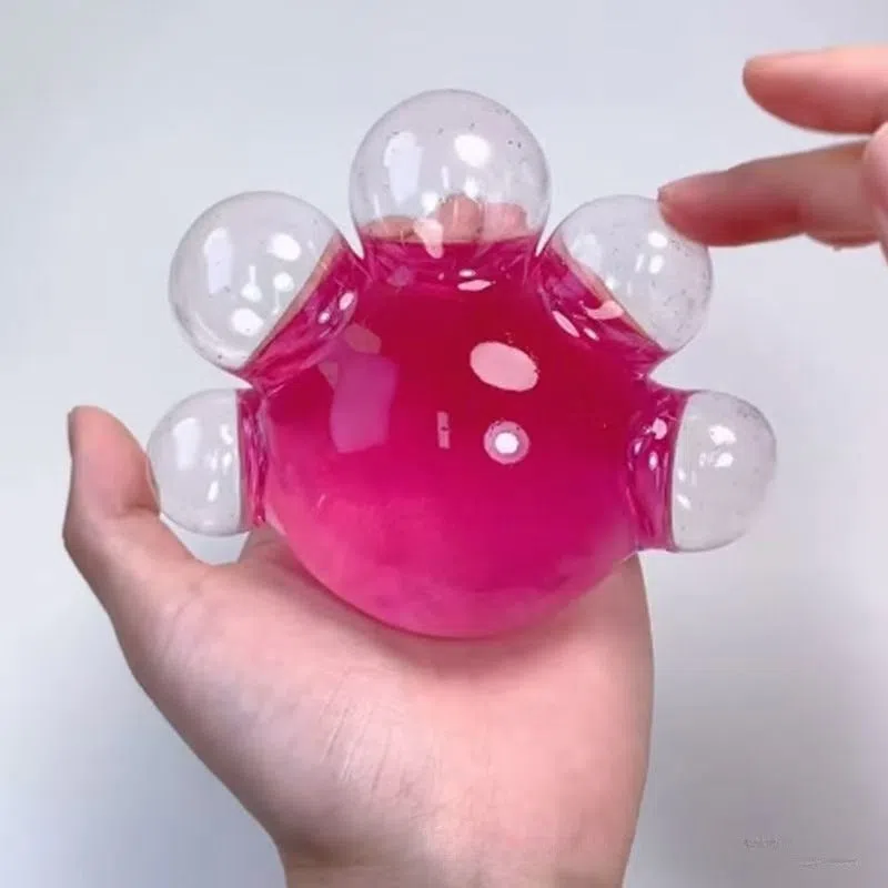 Decompression bubble slow rebound compressable musical toy in pink smiley ball design, made from TPR material for children's stress relief and sensory play
