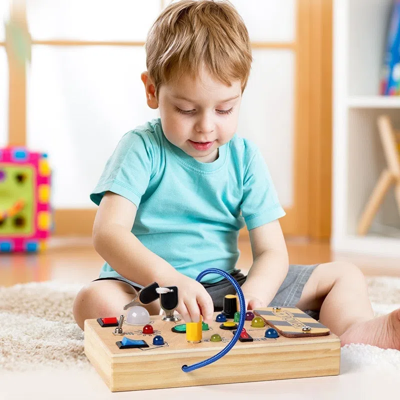 Wooden busy switch light toy on a table, showing switch panel and coloured light section.