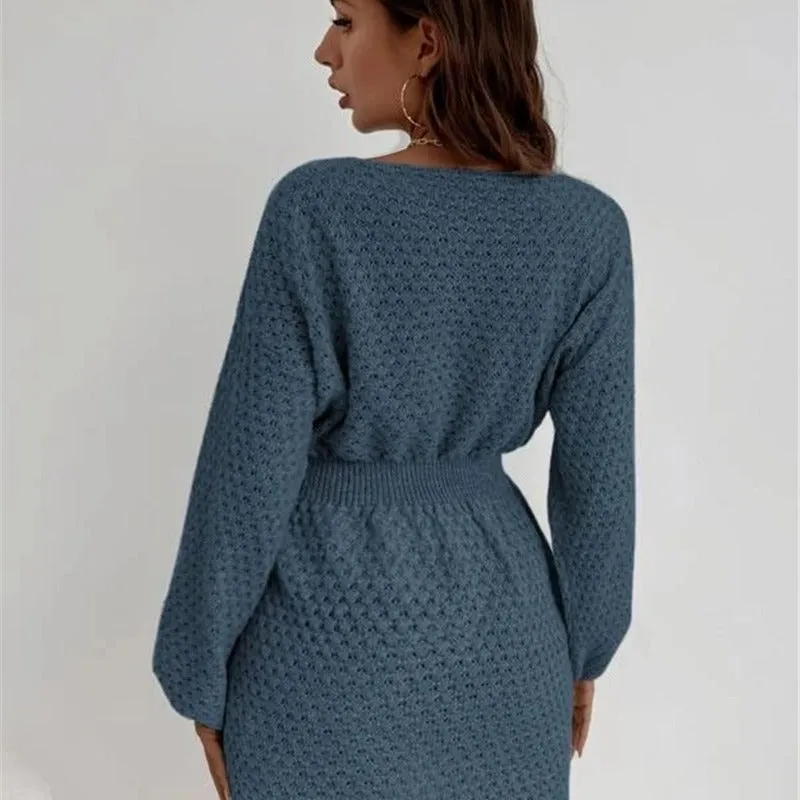 Blue women's knitted dress with crocheted flower details, round neck, fitted waist, and long sleeves.
