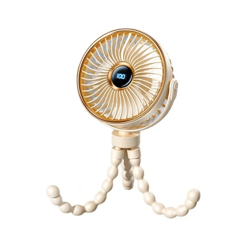 A beige portable clip-on fan with three blades, mounted on a stroller handle, showing its rotating head.