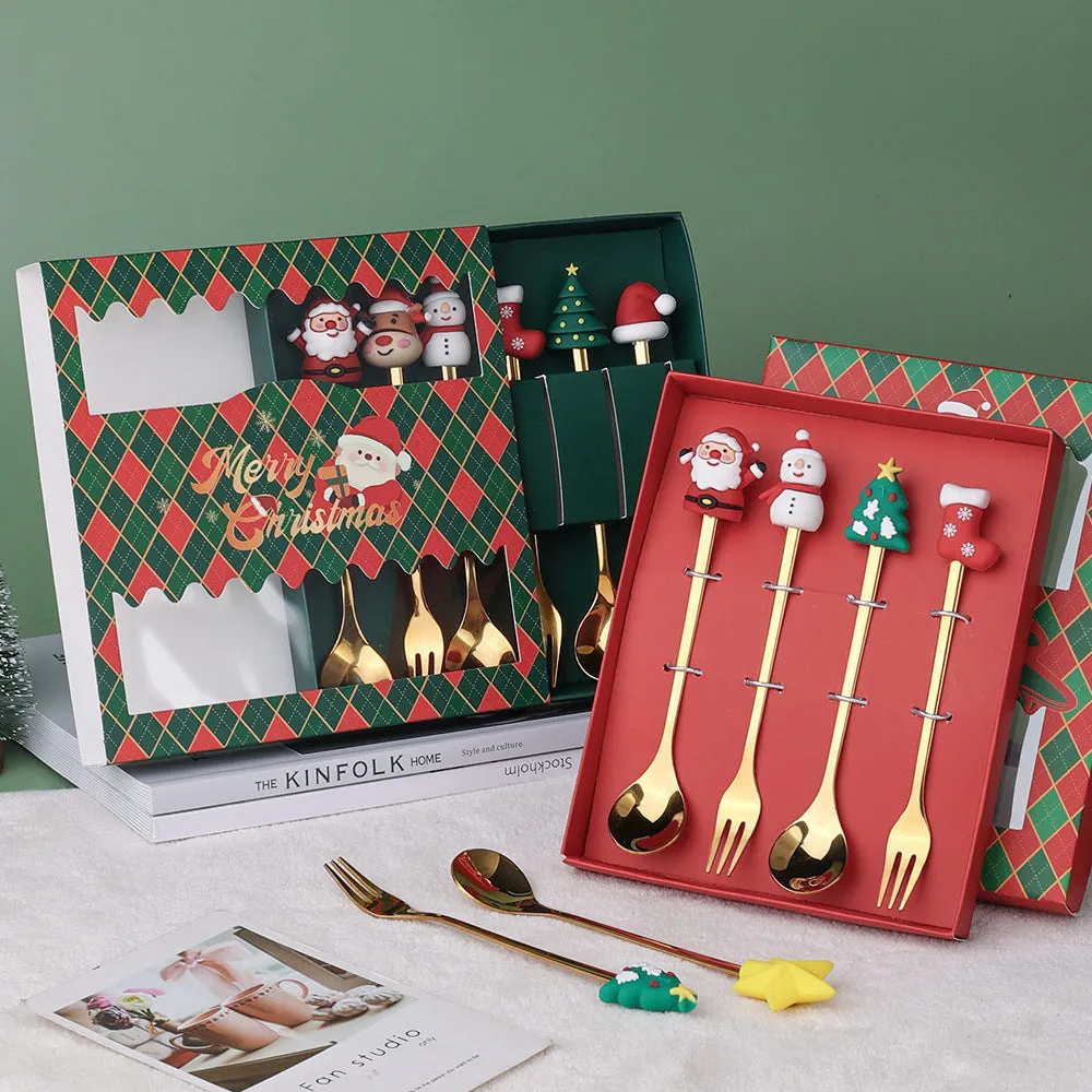 Red stainless steel Christmas spoon and fork set with snowman and Christmas tree designs on the handles.