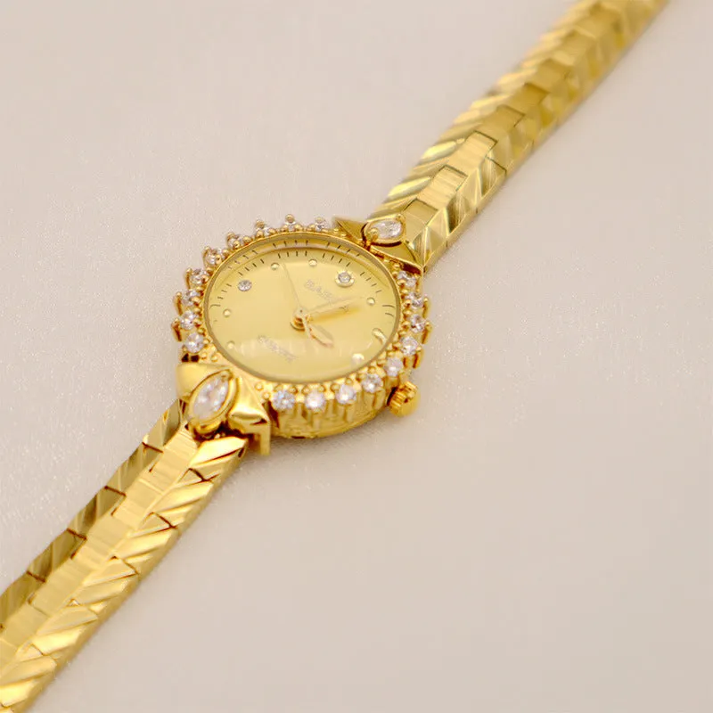 Women's vintage-style quartz watch with diamond-embossed dial and gold metal bracelet