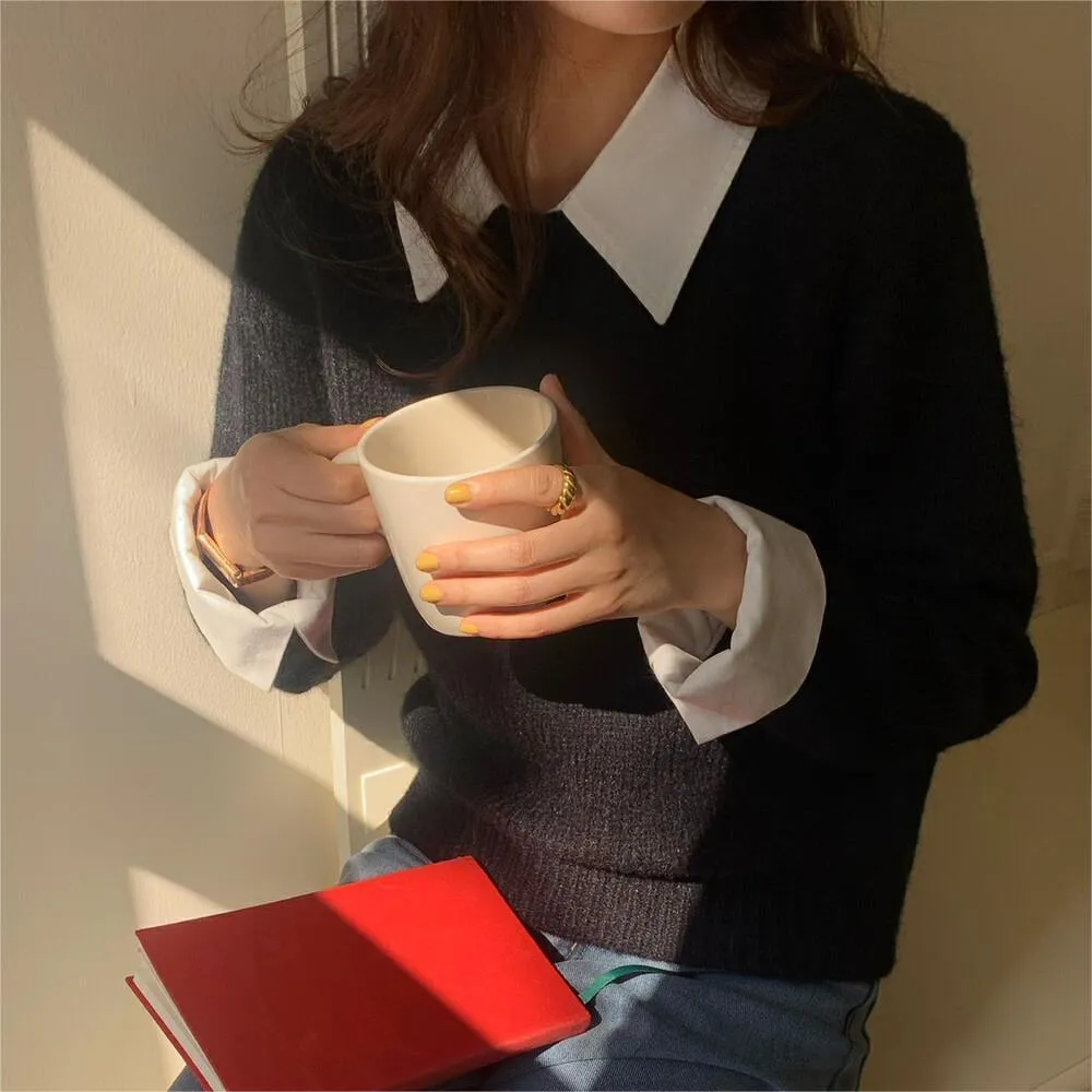 Women's loose knitwear top in navy blue with long sleeves and solid colour design