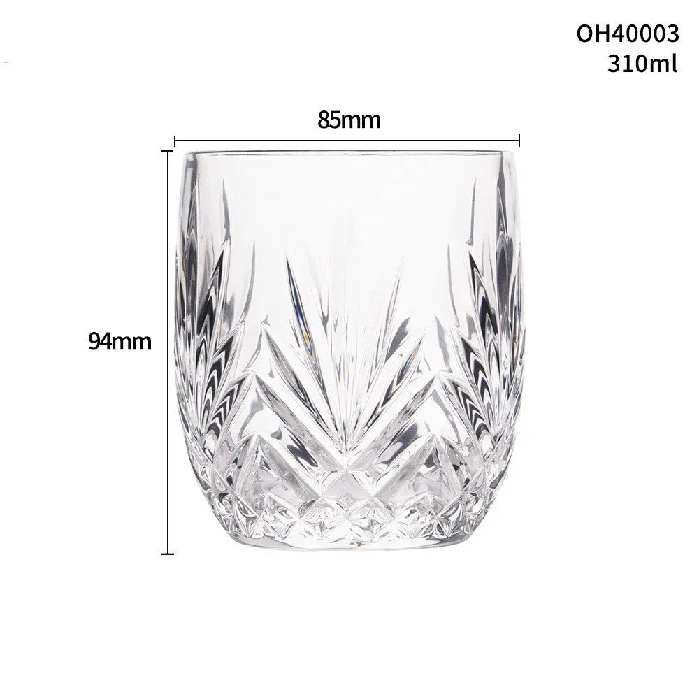 Clear crystal whiskey shot glass with a thick bottom on a wooden surface.
