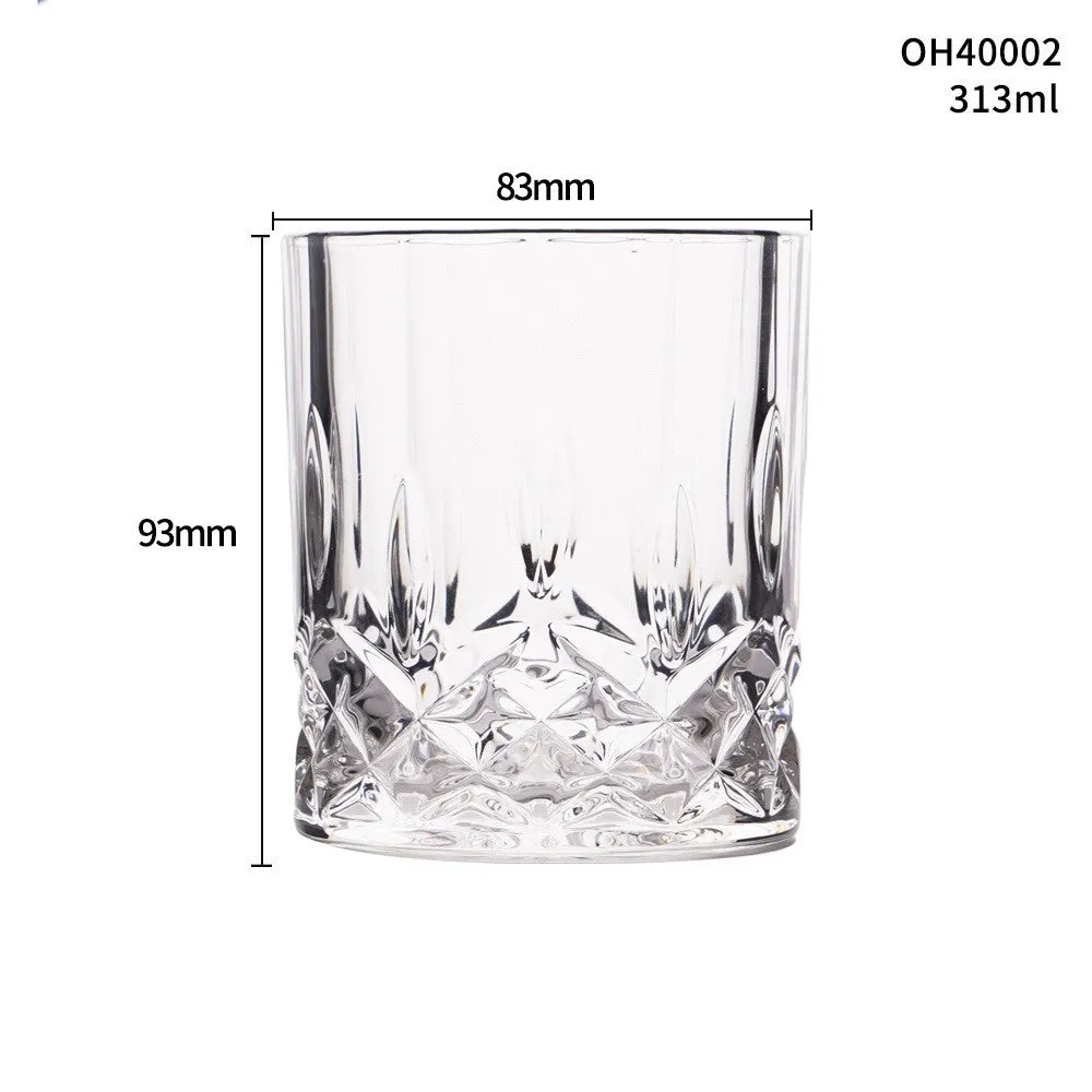 Clear crystal whiskey shot glass with a thick bottom on a wooden surface.