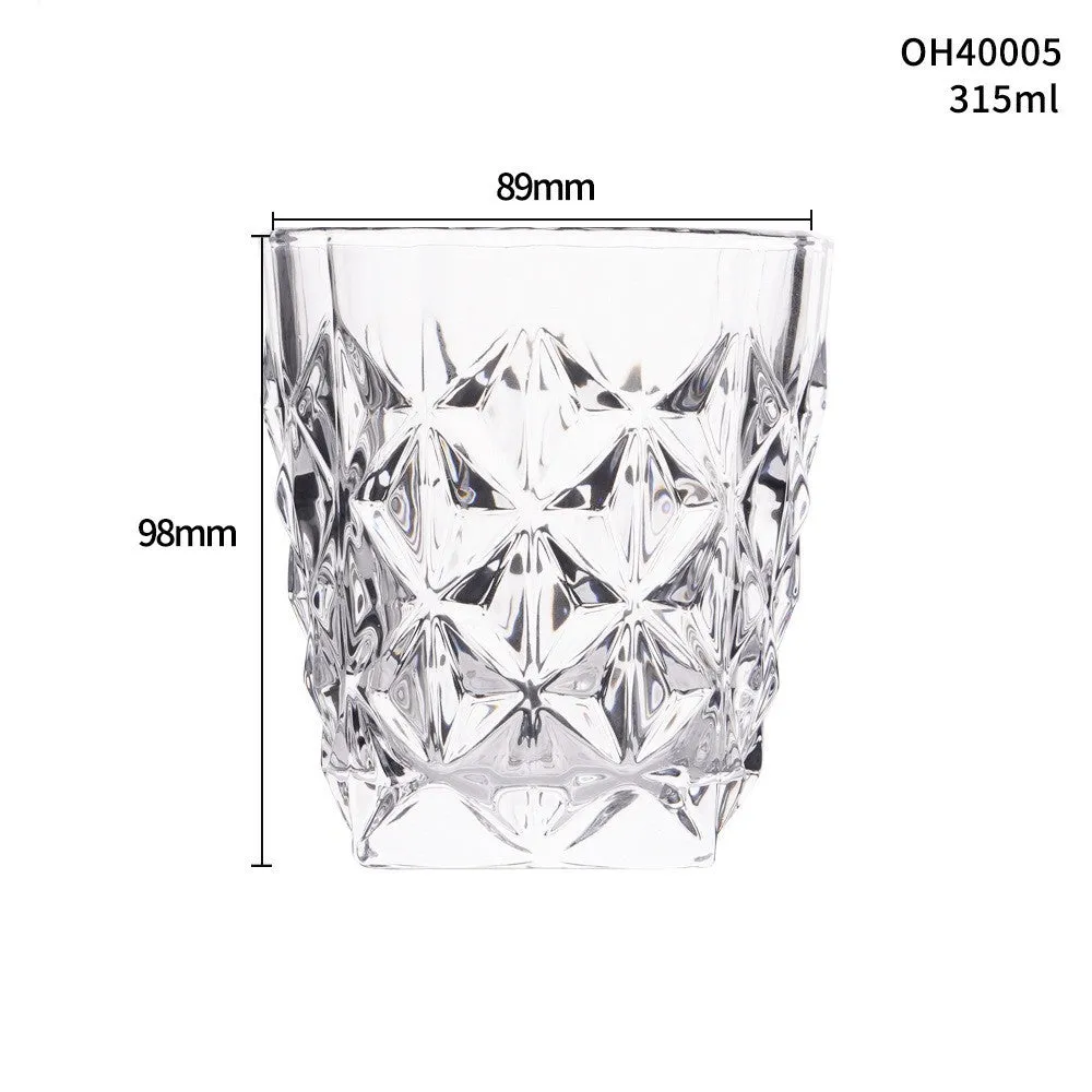 Clear crystal whiskey shot glass with a thick bottom on a wooden surface.