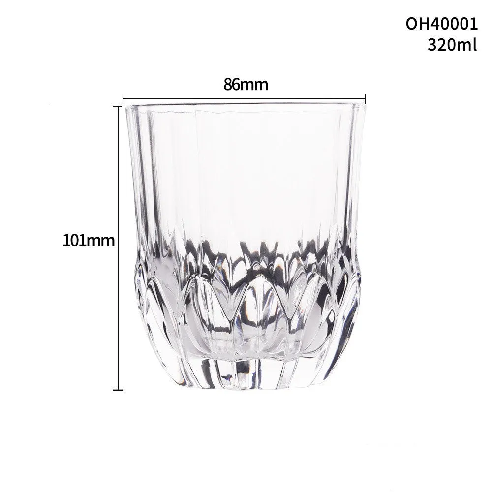 Clear crystal whiskey shot glass with a thick bottom on a wooden surface.