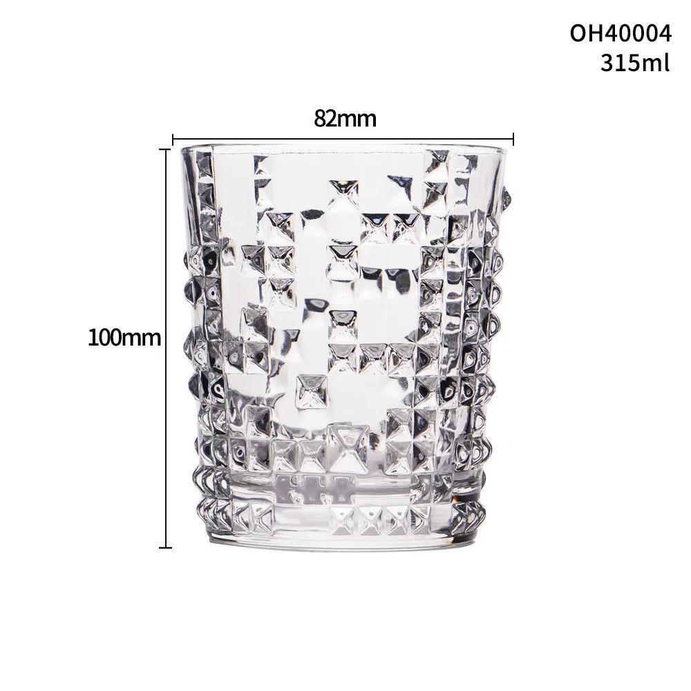 Clear crystal whiskey shot glass with a thick bottom on a wooden surface.