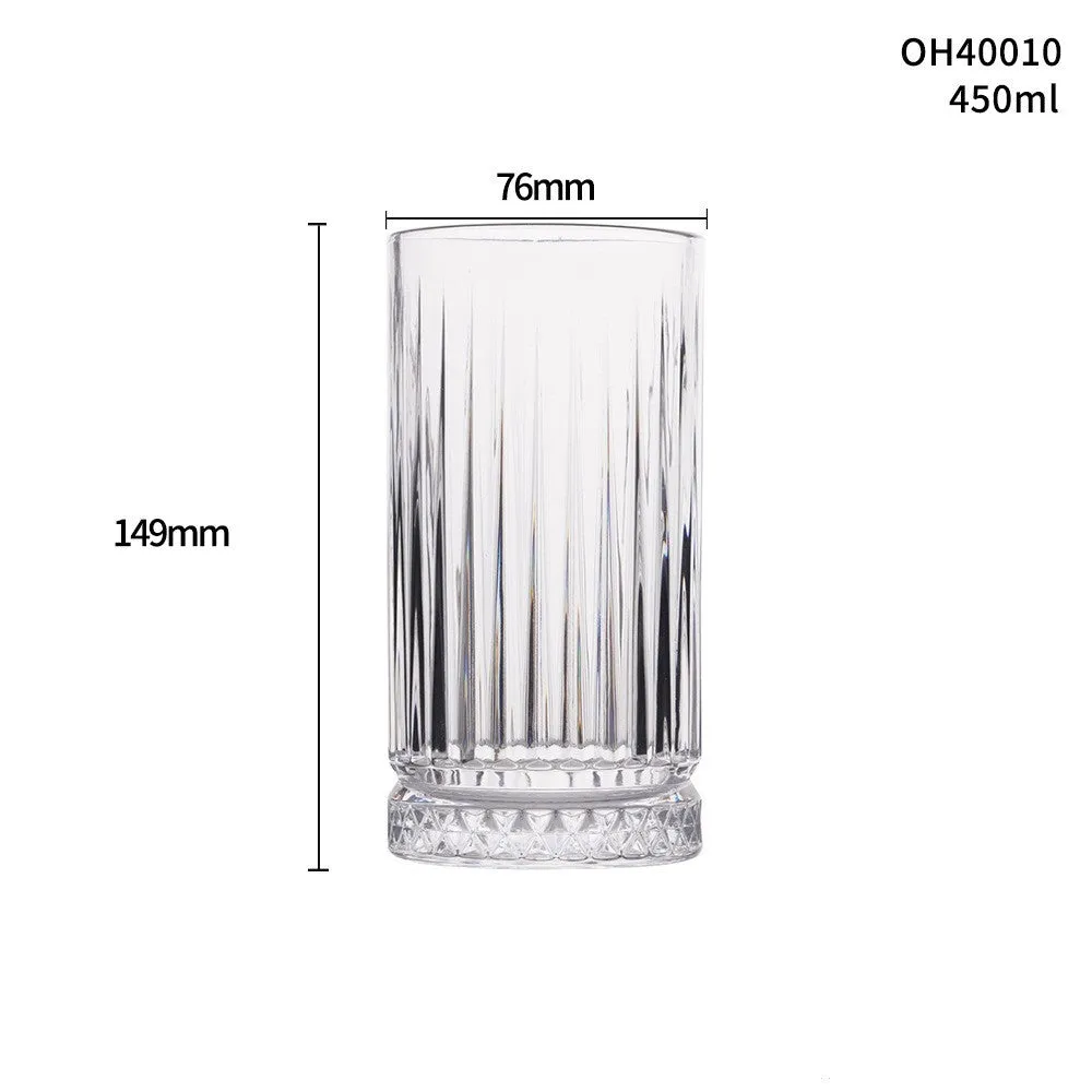 Clear crystal whiskey shot glass with a thick bottom on a wooden surface.