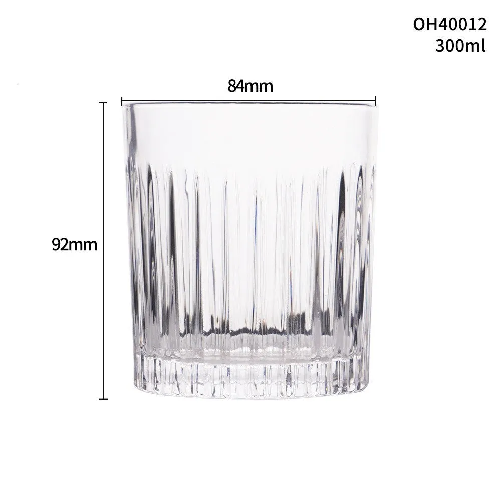 Clear crystal whiskey shot glass with a thick bottom on a wooden surface.