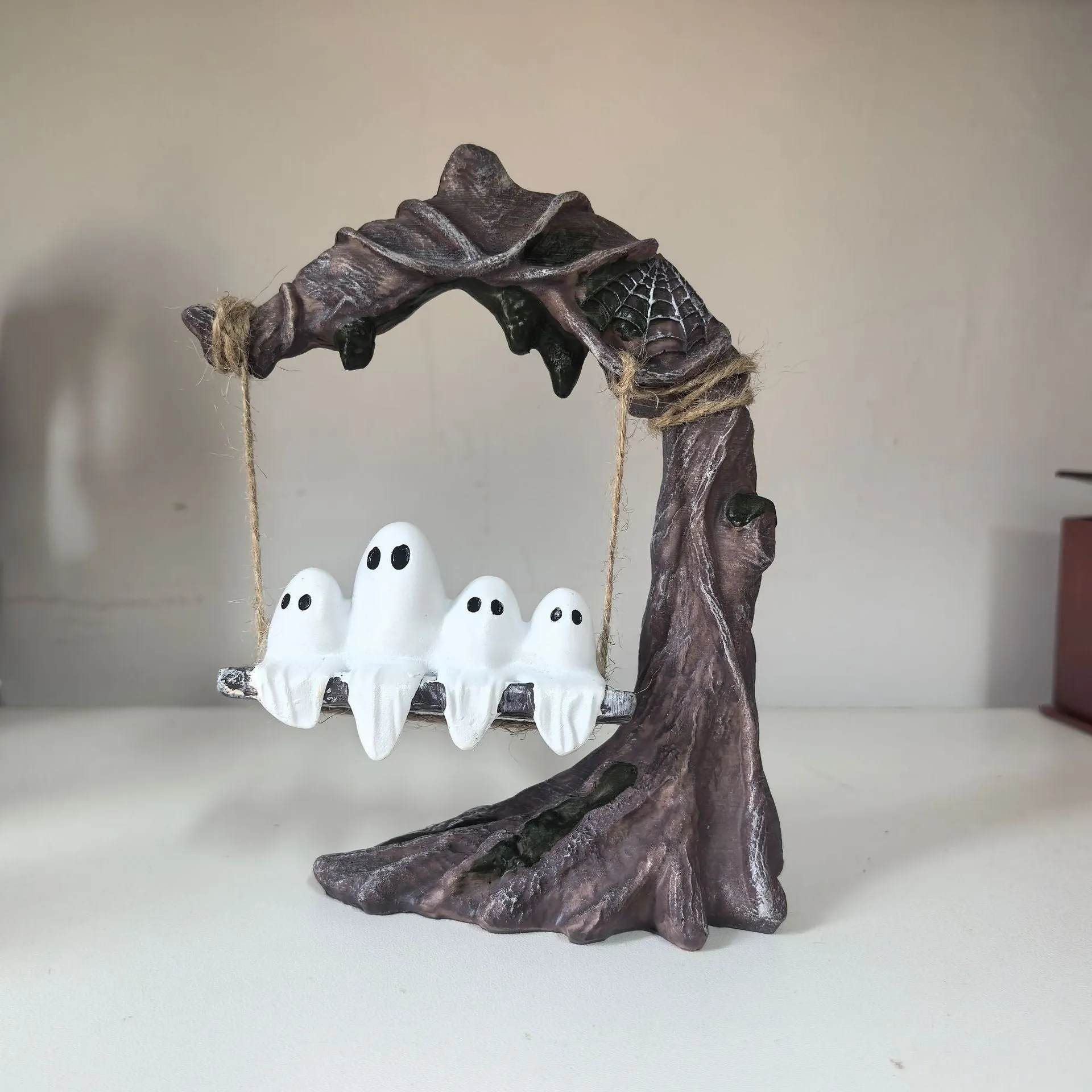 Halloween swing ghost decoration in resin showing two style options with modern art design