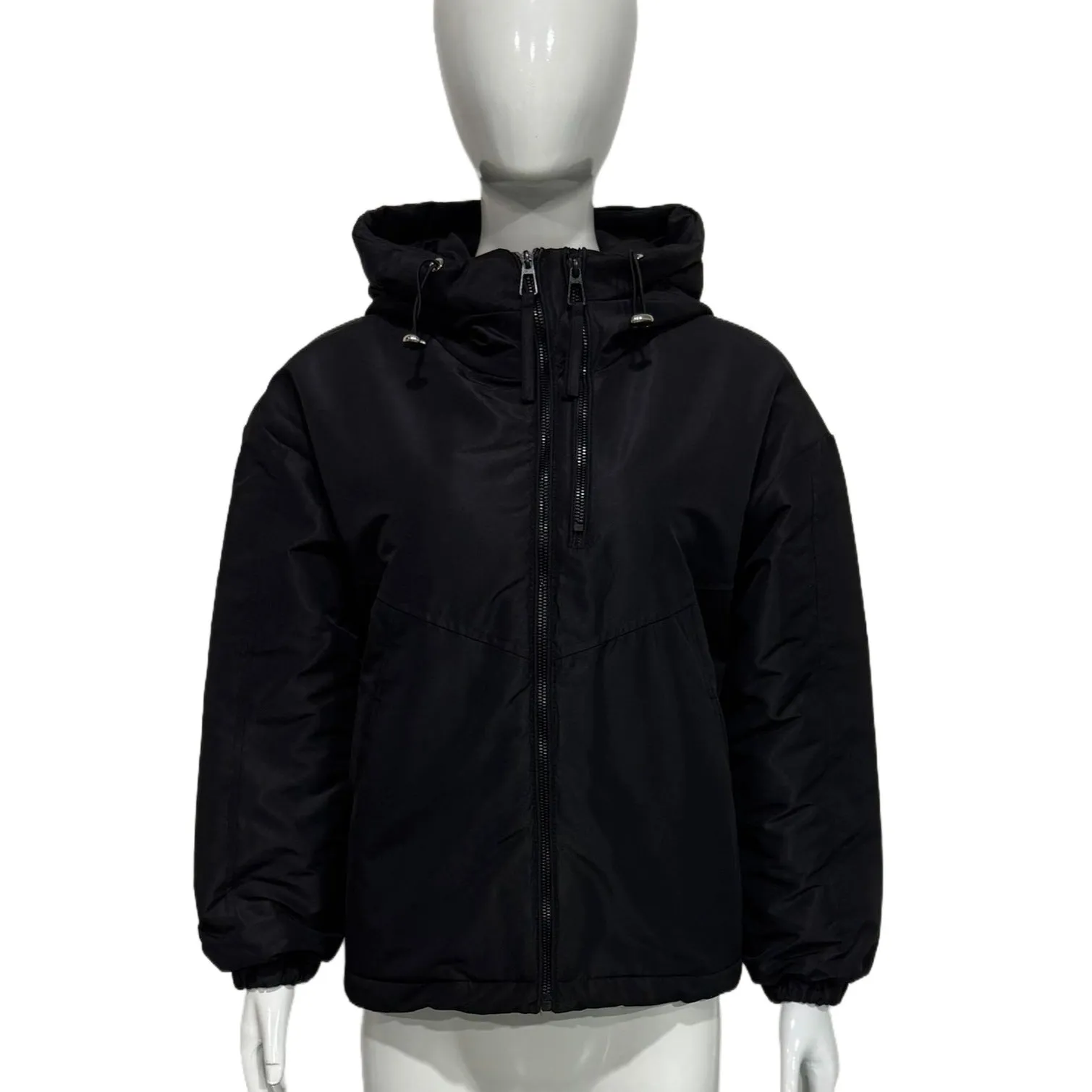 Grey women's loose-fit hooded polyester shell jacket with long sleeves on a hanger.