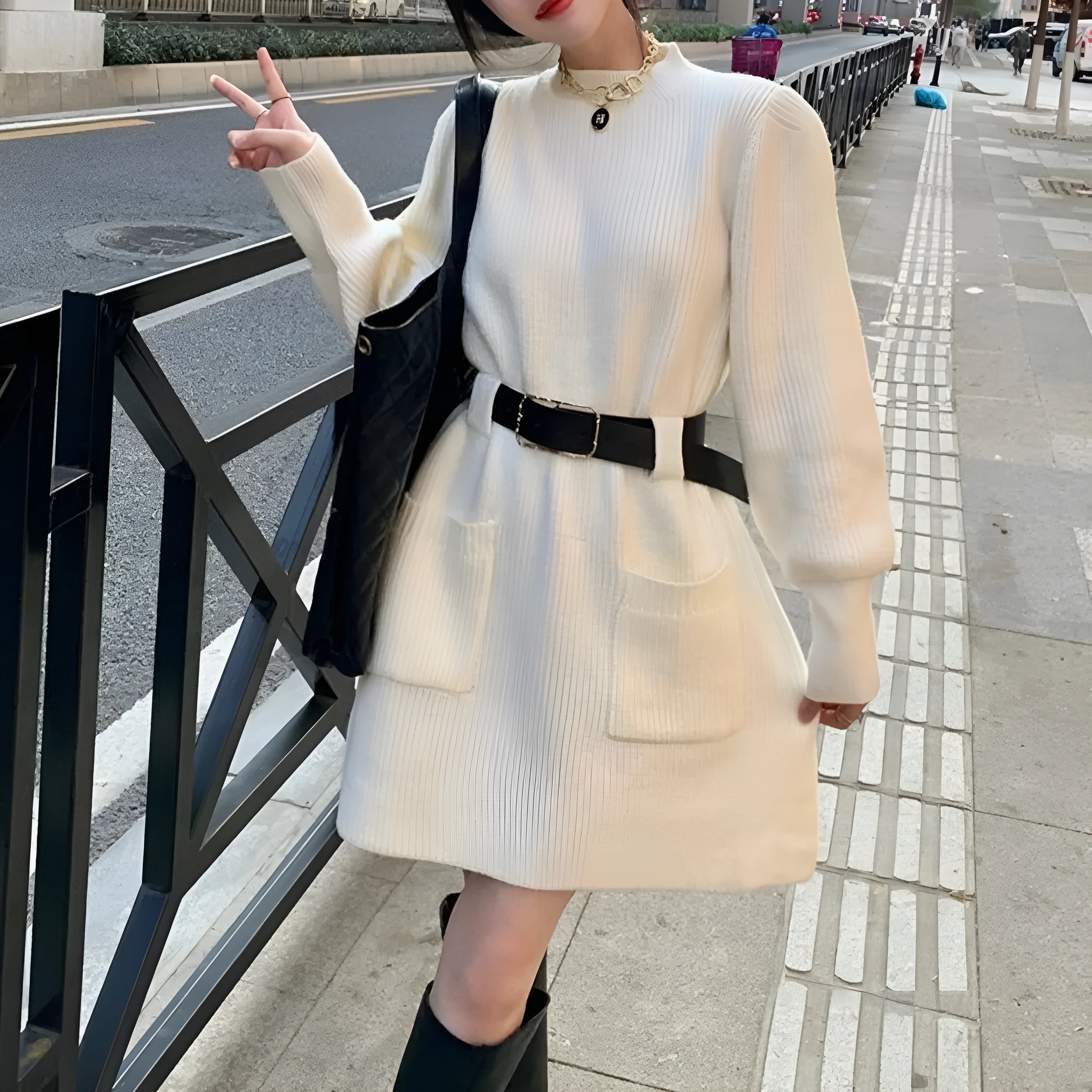 Women's loose knitted dress with long sleeves and high waist, shown in beige with black belt