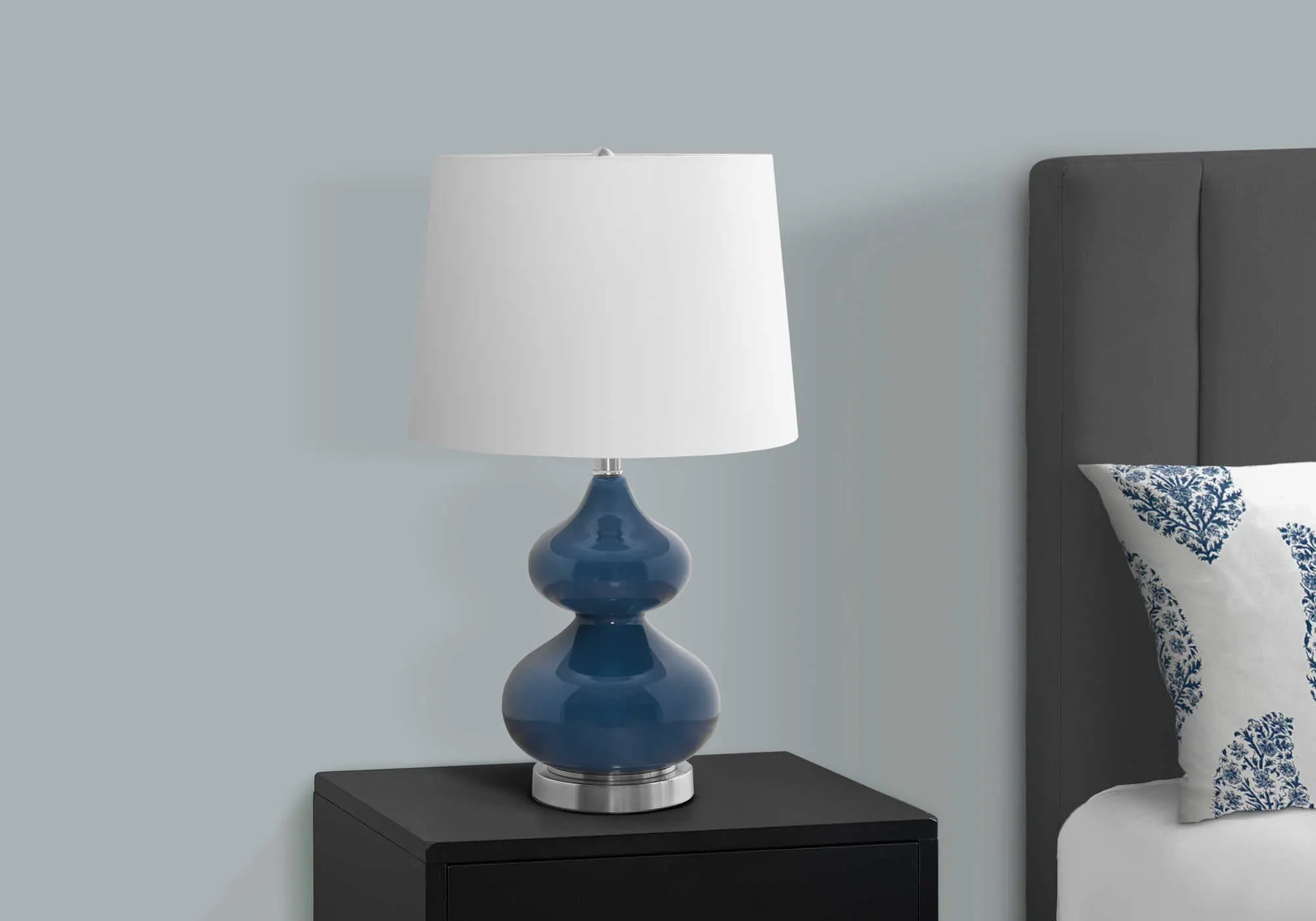 Blue crystal glass desk lamp with a cloth shade for a child's bedroom, shown on a desk.