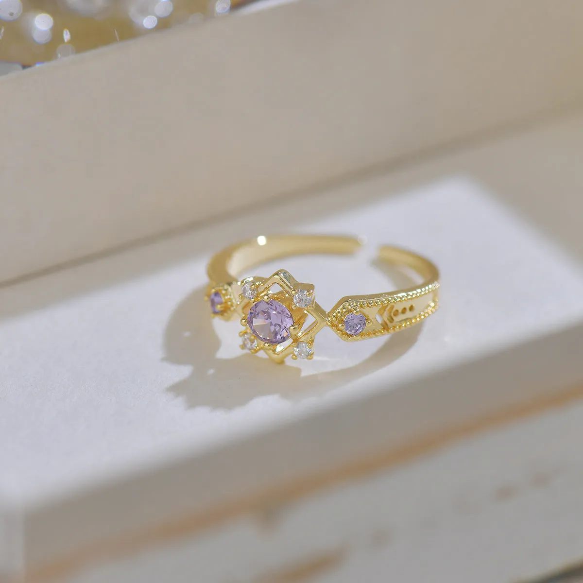 Geometric French style women's ring with purple zircon stones and open mouth adjustable design.