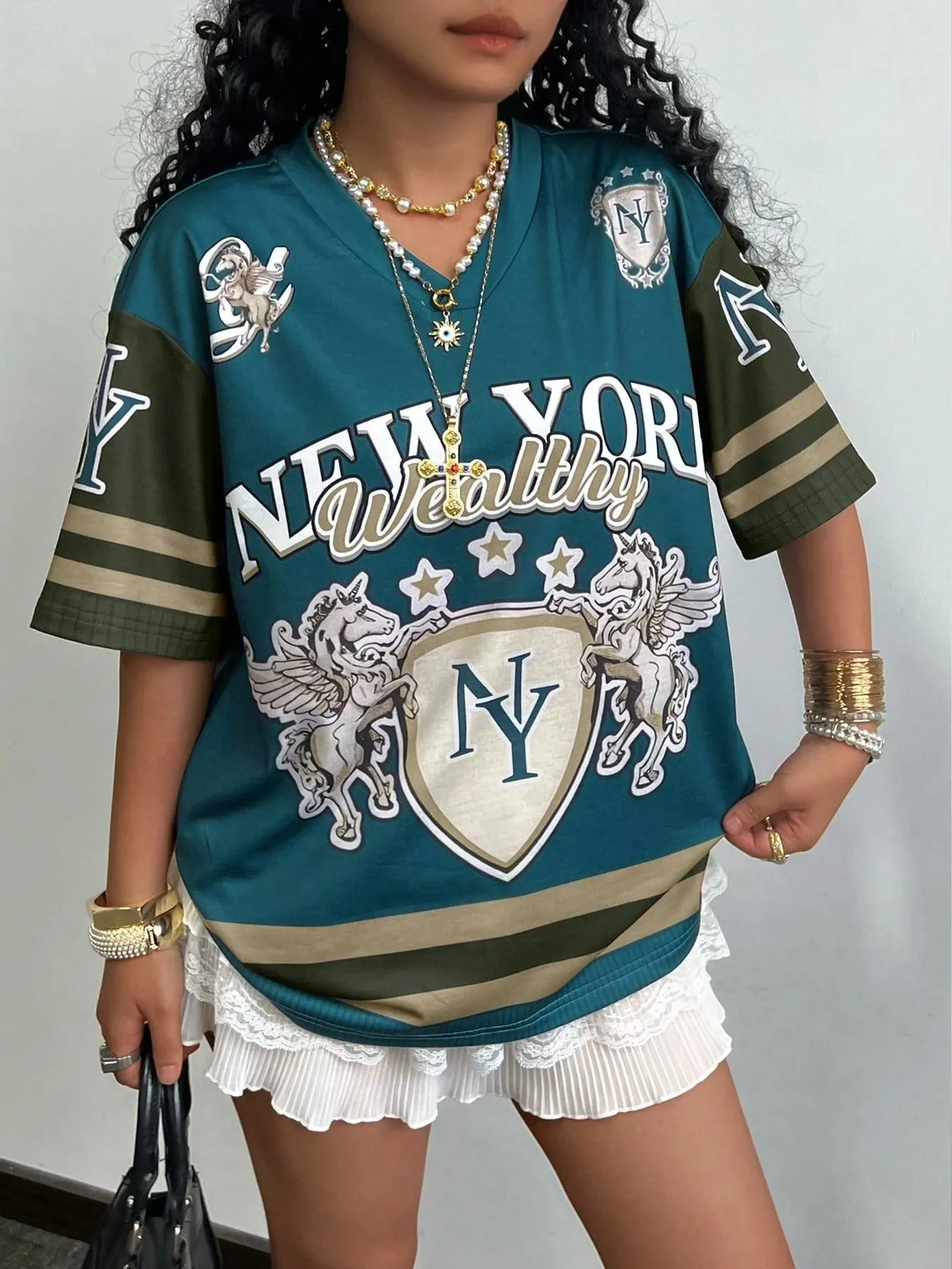 Loose fit women's V-neck short sleeve t-shirt featuring 3D raised letter printing in a solid colour.