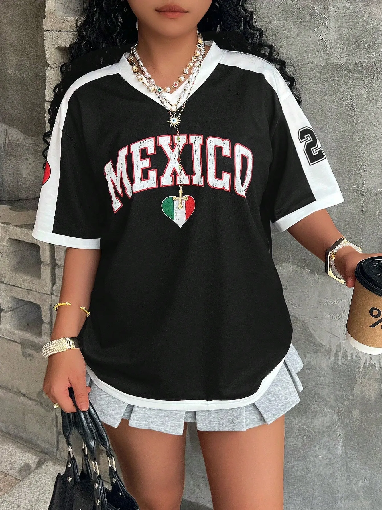 Loose fit women's V-neck short sleeve t-shirt featuring 3D raised letter printing in a solid colour.