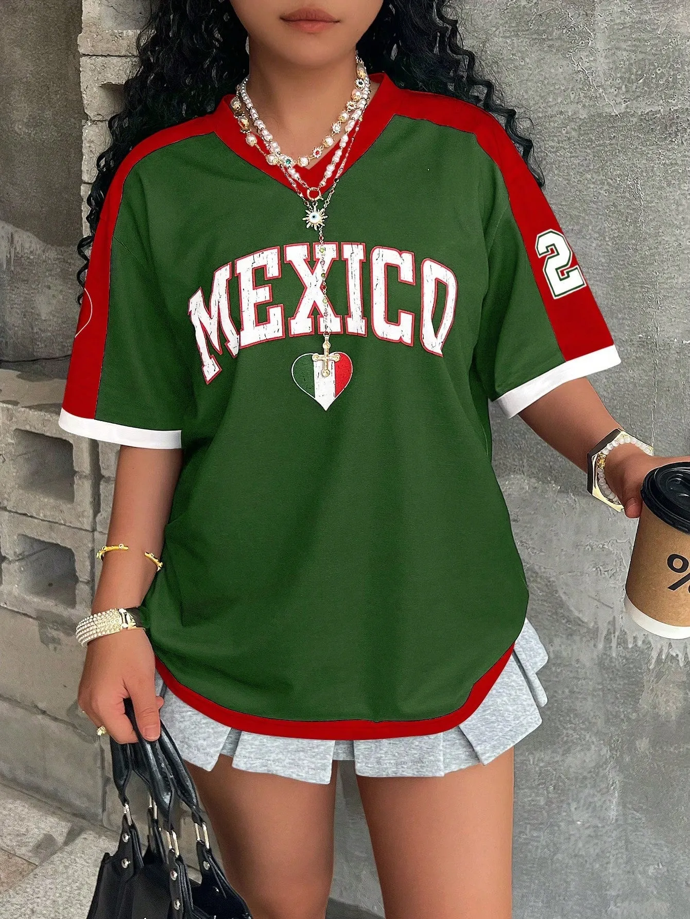 Loose fit women's V-neck short sleeve t-shirt featuring 3D raised letter printing in a solid colour.