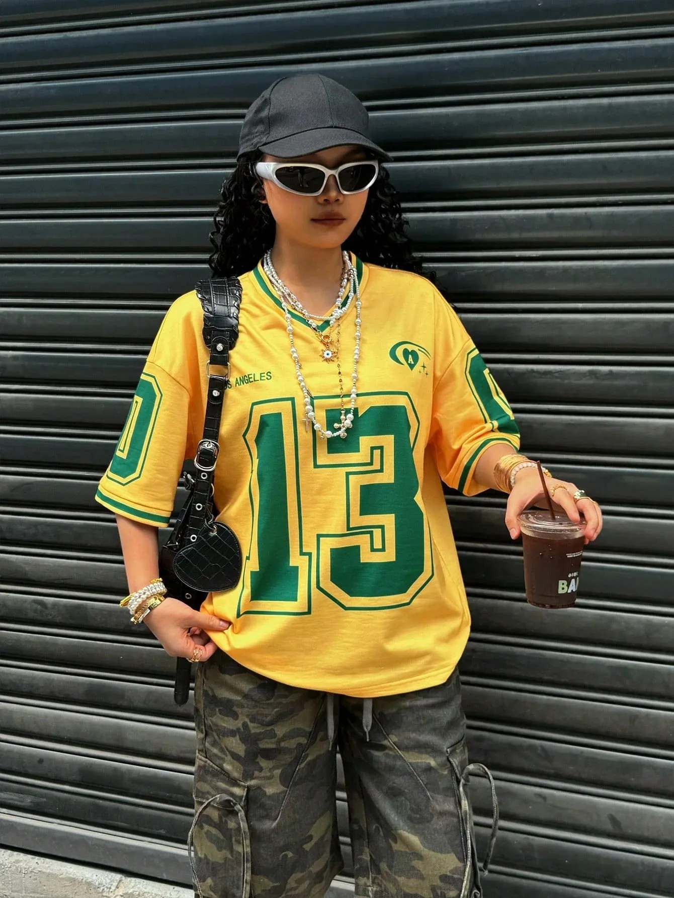 Loose fit women's V-neck short sleeve t-shirt featuring 3D raised letter printing in a solid colour.